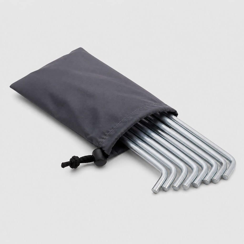 Huit clous de tente en titane rangés dans une pochette souple